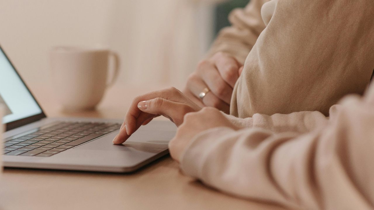 A couple looking at their laptop together 