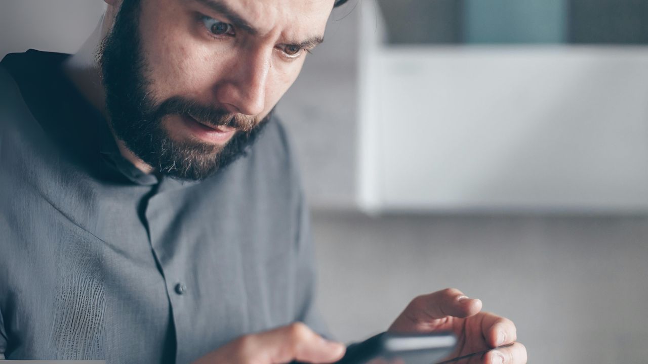 Man trying to discern a phone update notification 