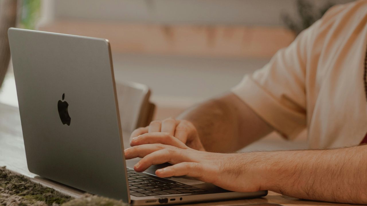 A man typing on a laptop 