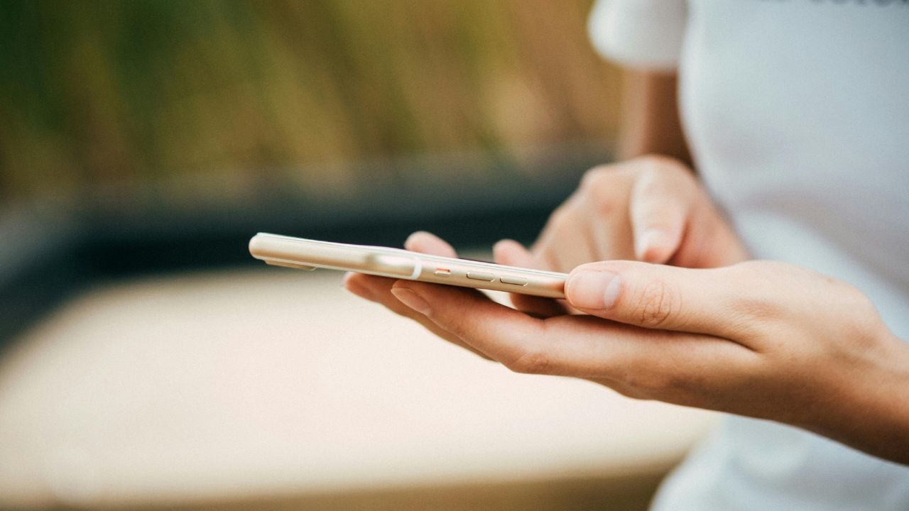 A woman receiving a phone update notification on her phone 