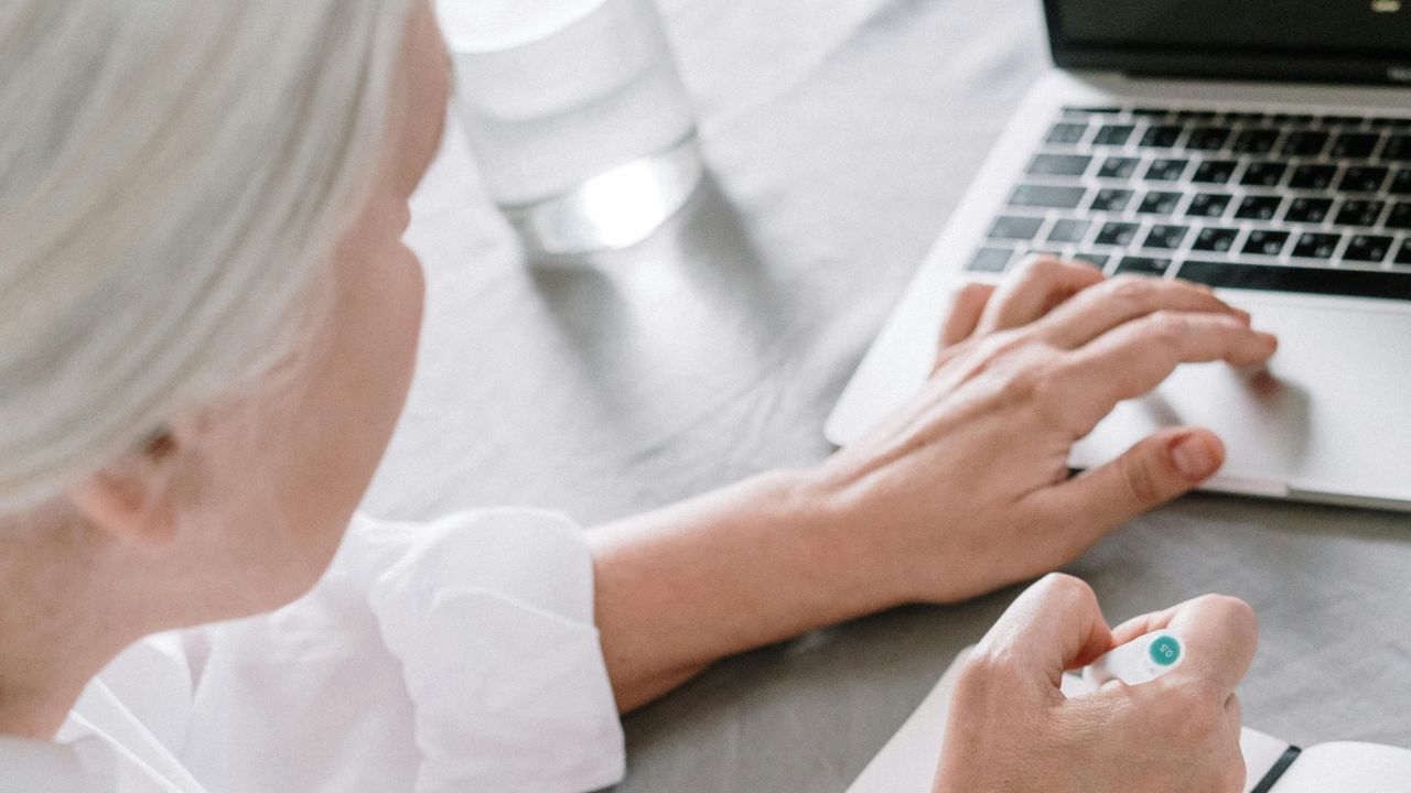 A woman typing on a laptop