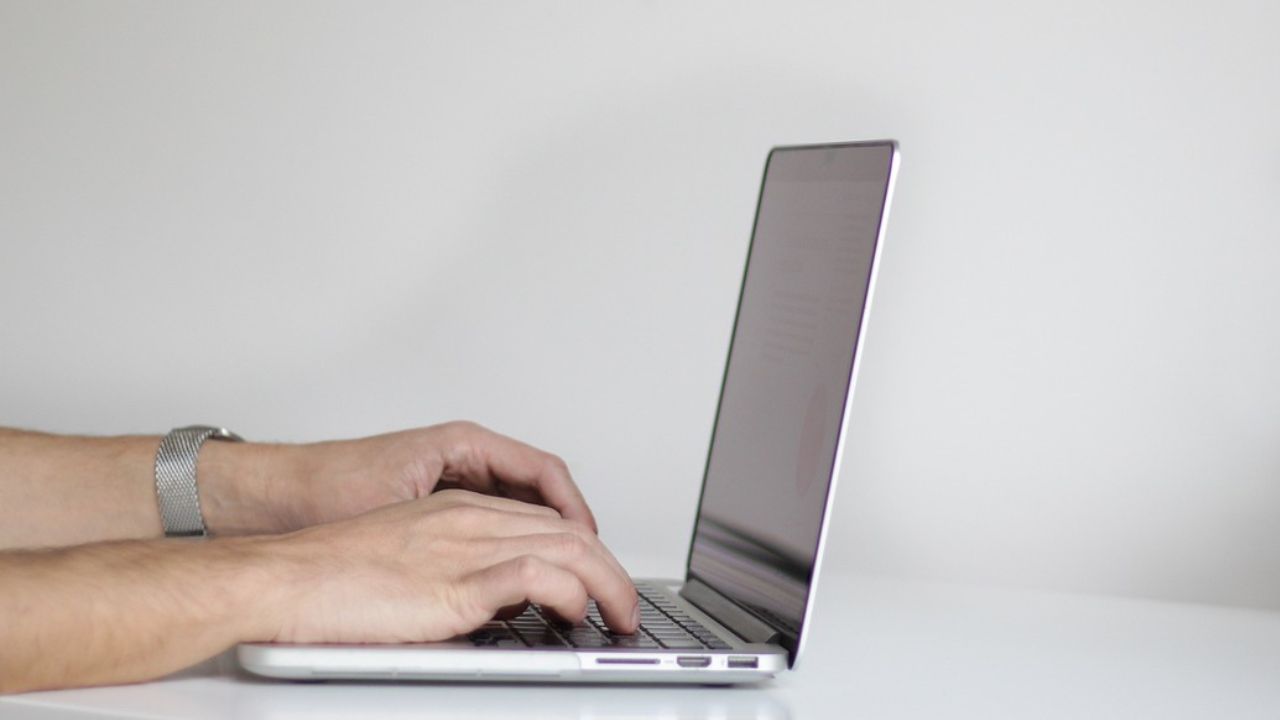 A man typing on a laptop 