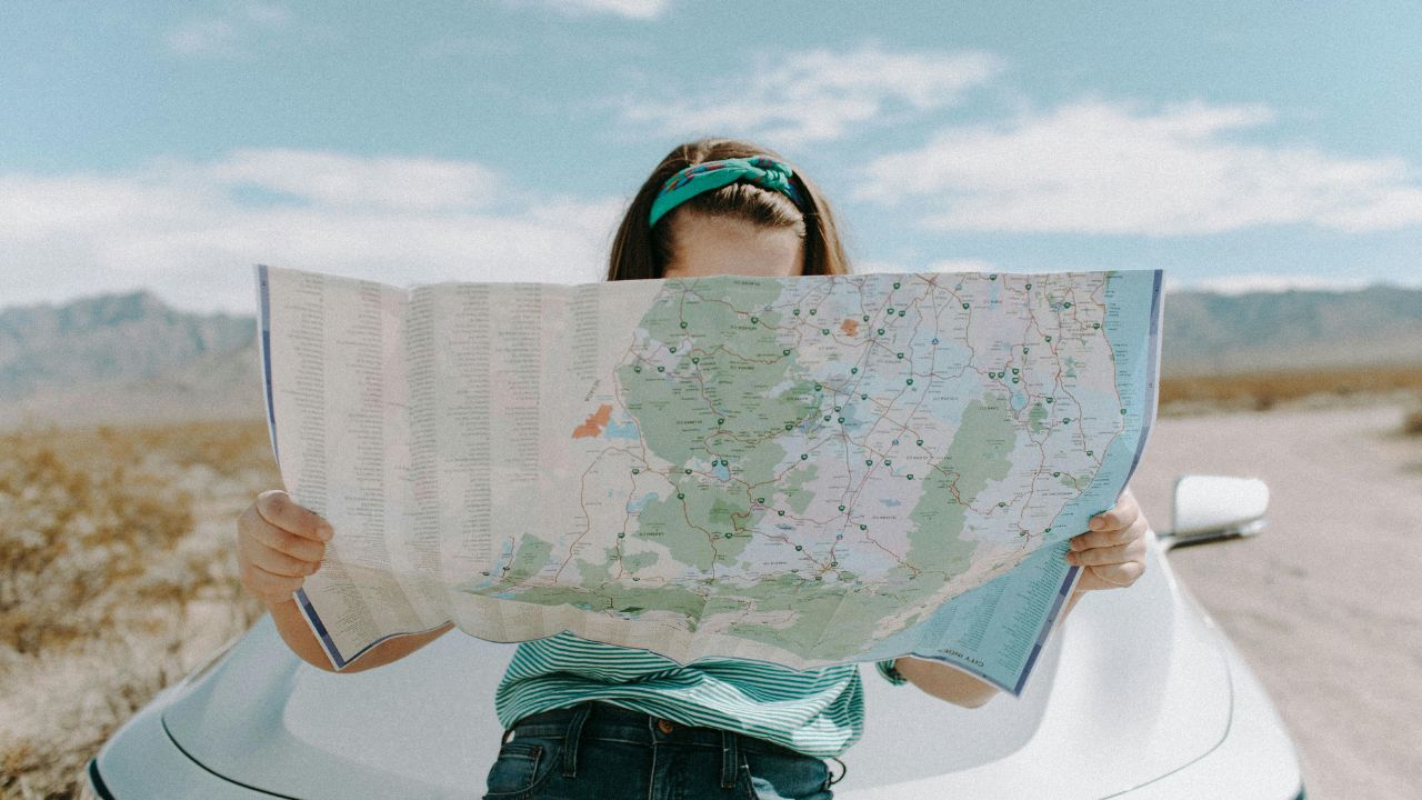 A woman looking at a map on her vacation 