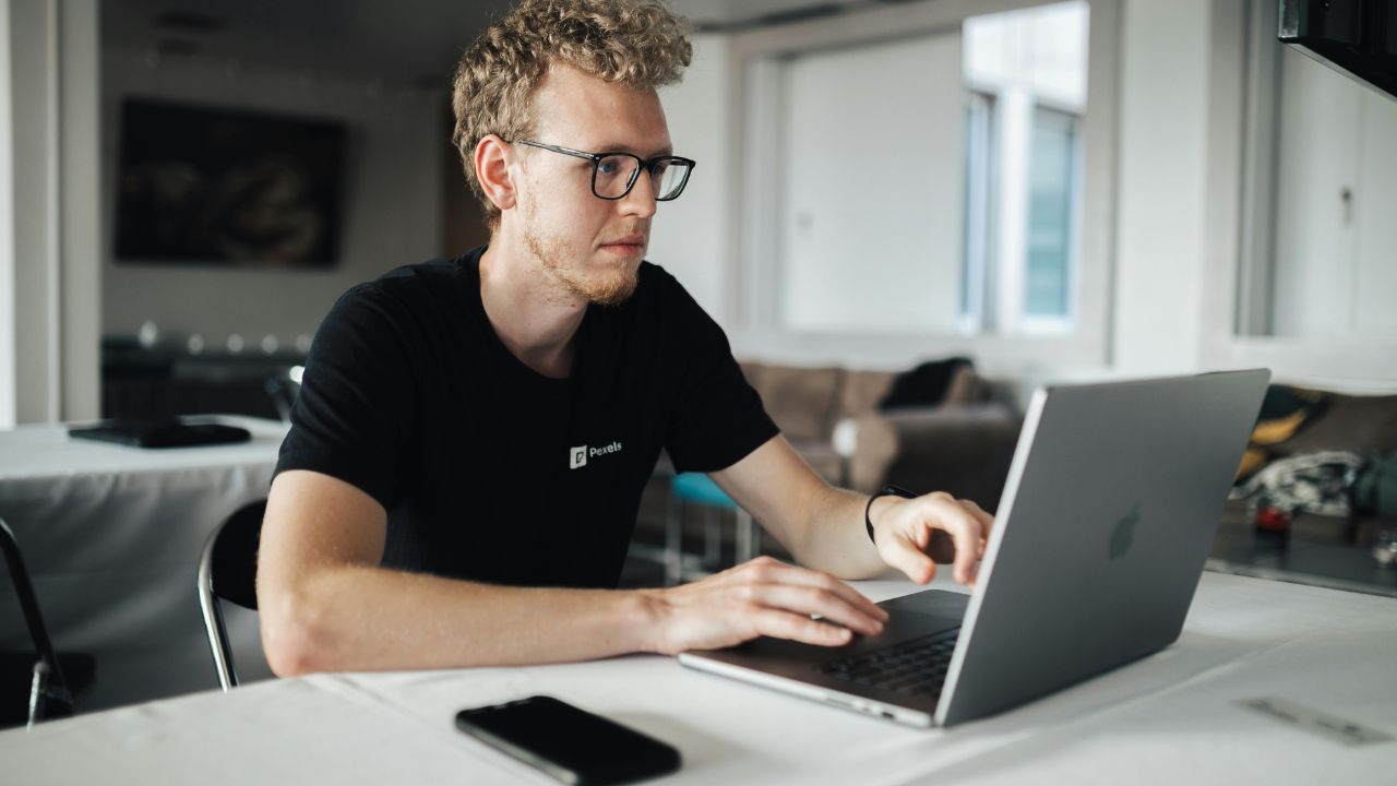 A man typing on her computer 