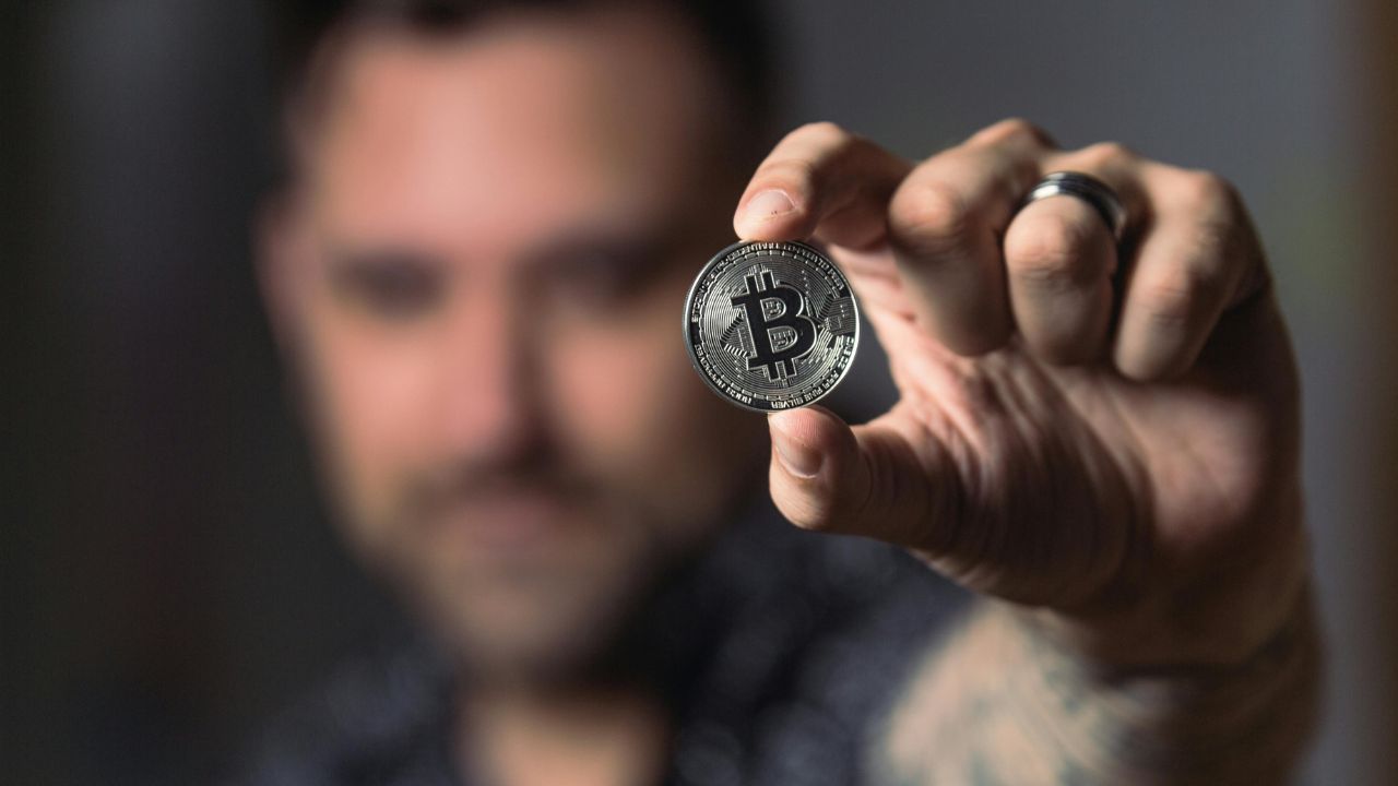 A man holding cryptocurrency in his hand 