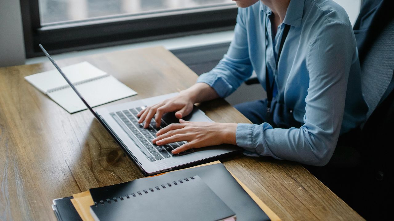 A woman typing on her laptop 