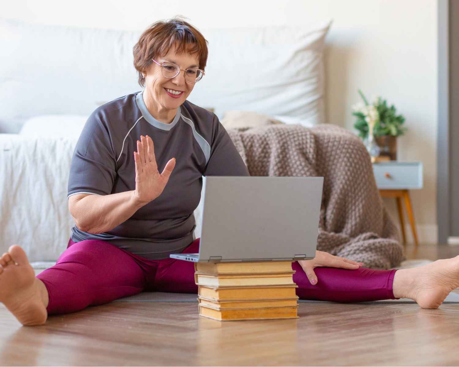 A woman in workout clothes takes an online class