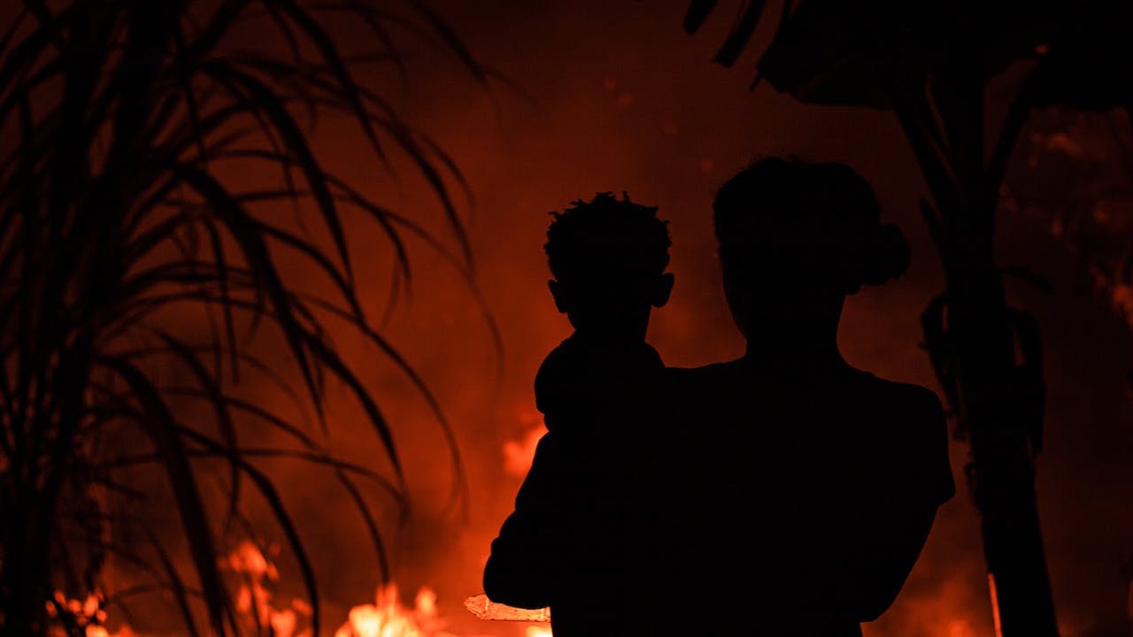 Silhouetted Family in Front of a Dramatic Fire