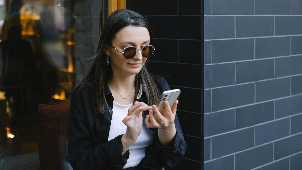 A woman looking at an international call coming in on her phone 