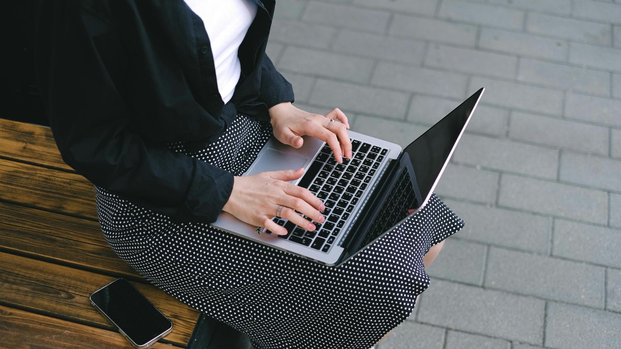 A woman typing on her laptop 