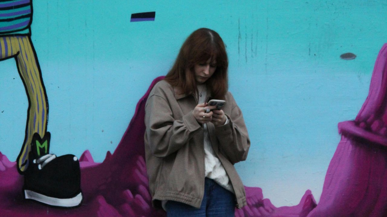 A woman looking at an international call coming in on her cell phone 