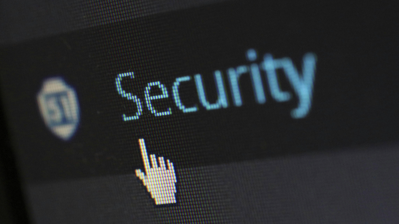 A stock photo of a screen showing a mouse pointer and the word 'Security'. 