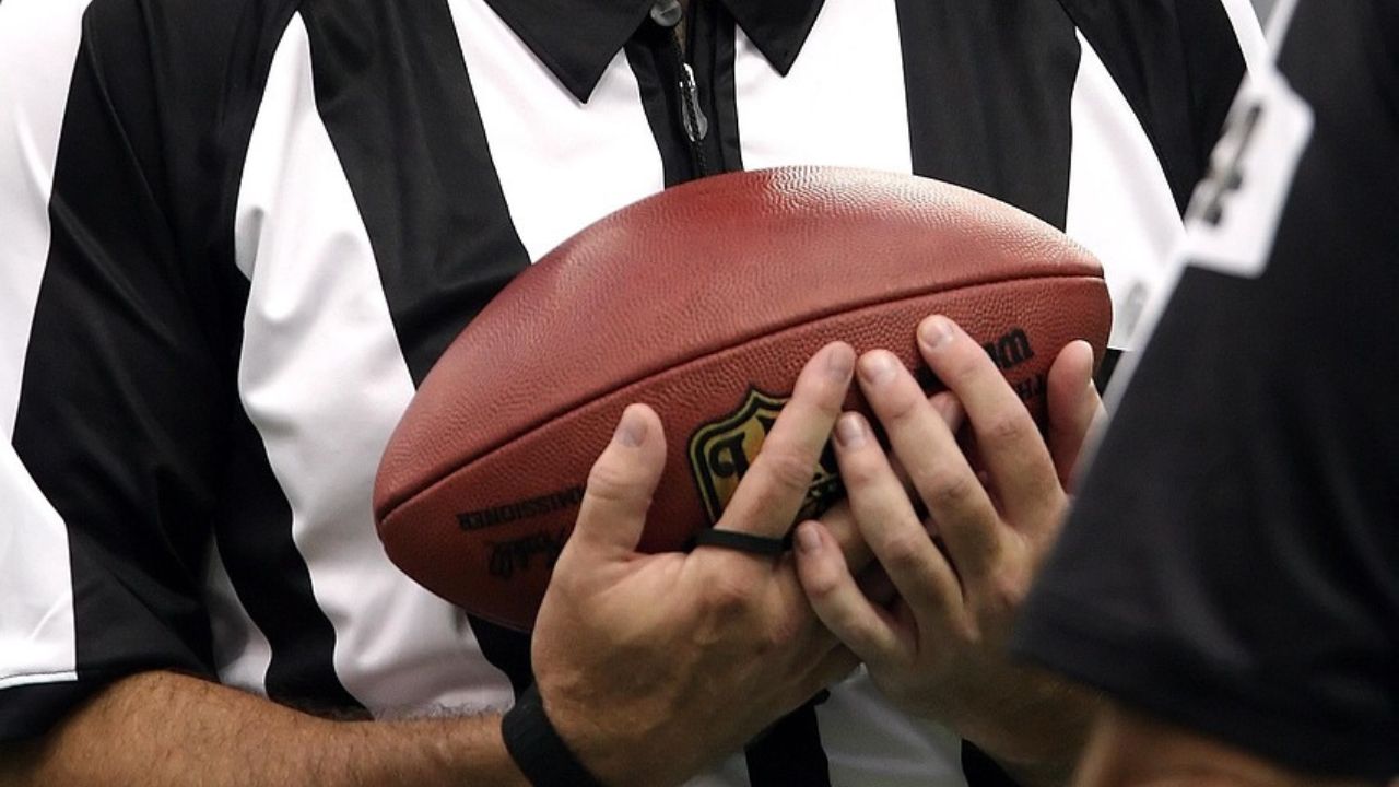 NFL referee holding official game ball 