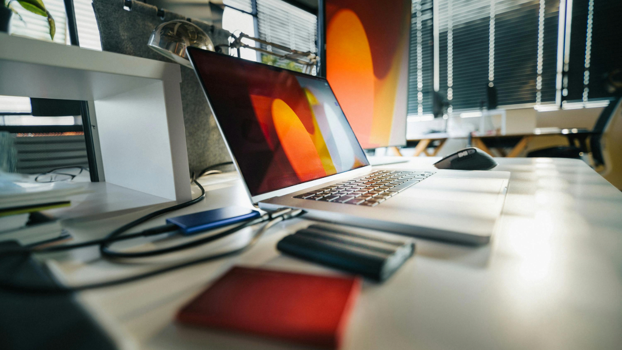 A stock photo showing a laptop plugged into an external harddrive