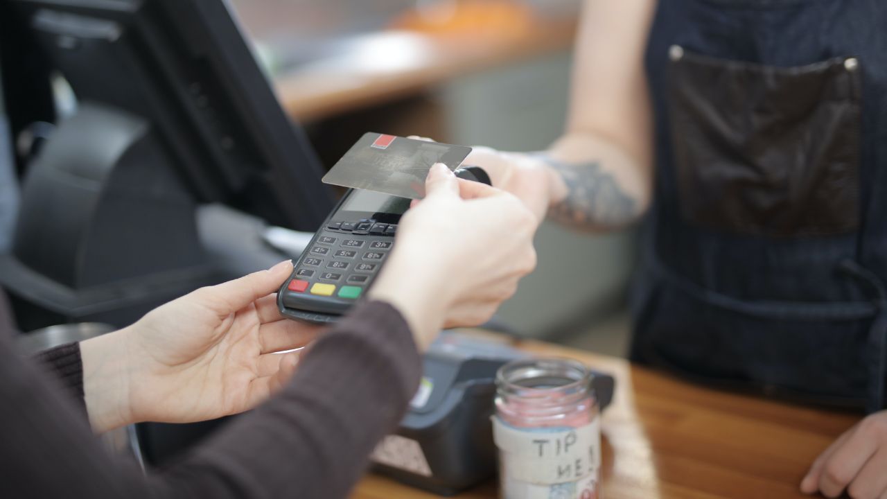 A person is paying using card