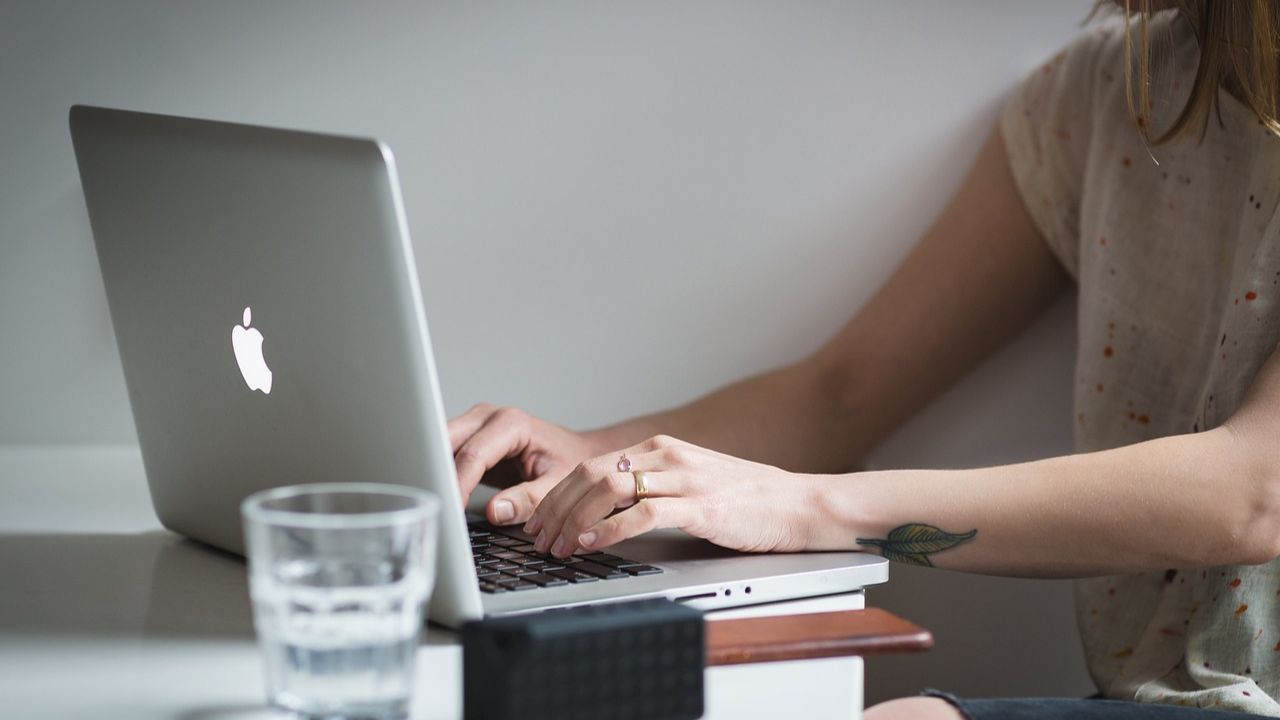 A woman typing on her laptop