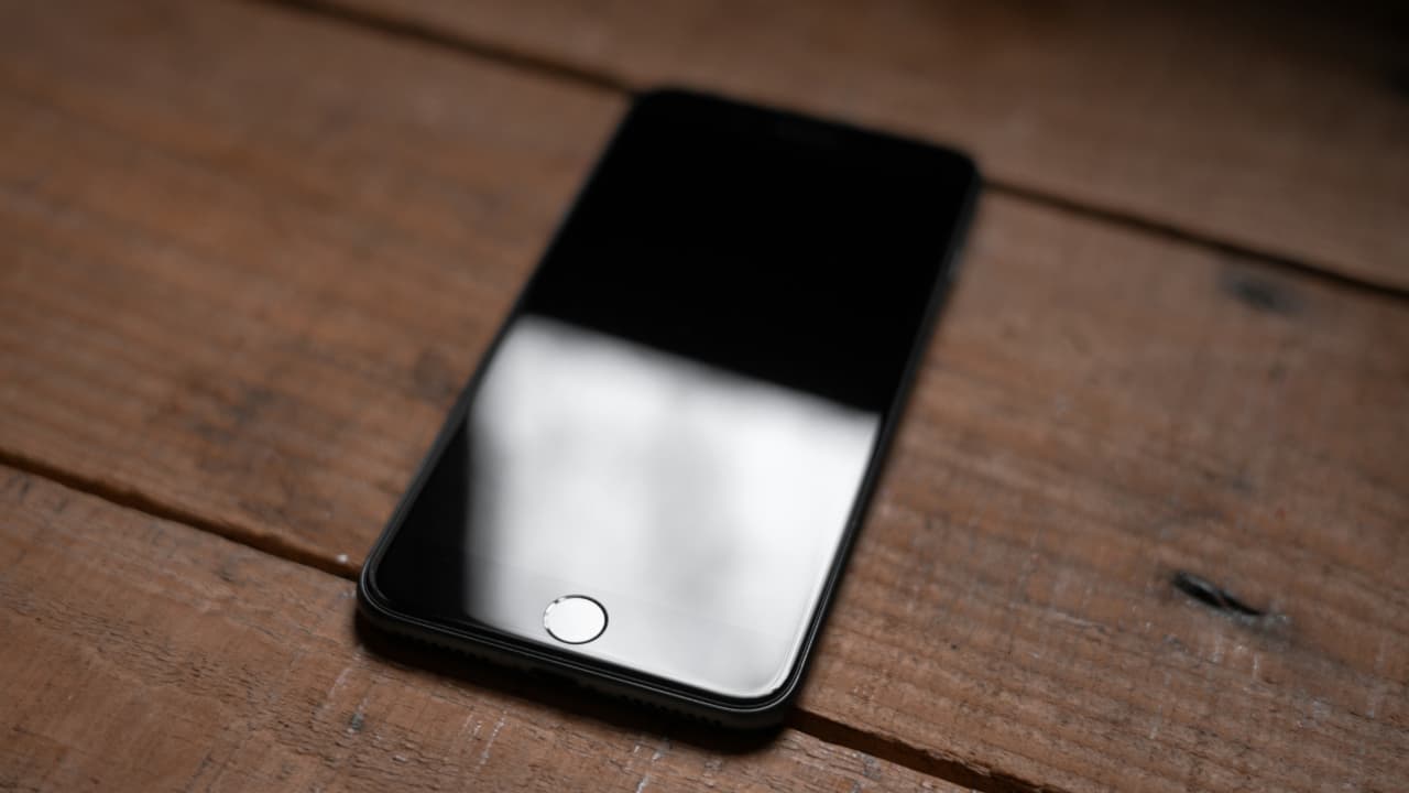An iPhone kept on a wooden surface