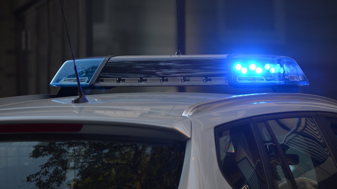 The top of a police car, with the lights flashing.