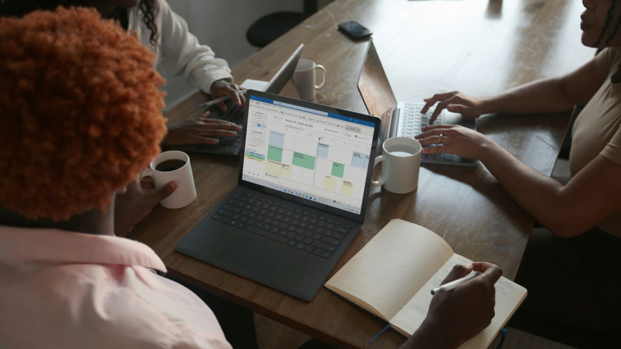 Woman on laptop looking at Microsoft Outlook calendar