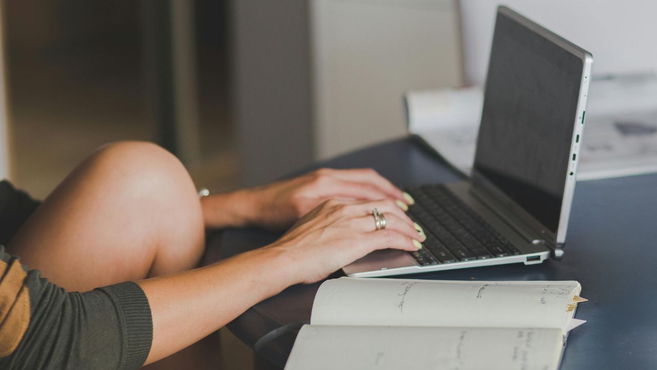 A woman typing on her laptop 