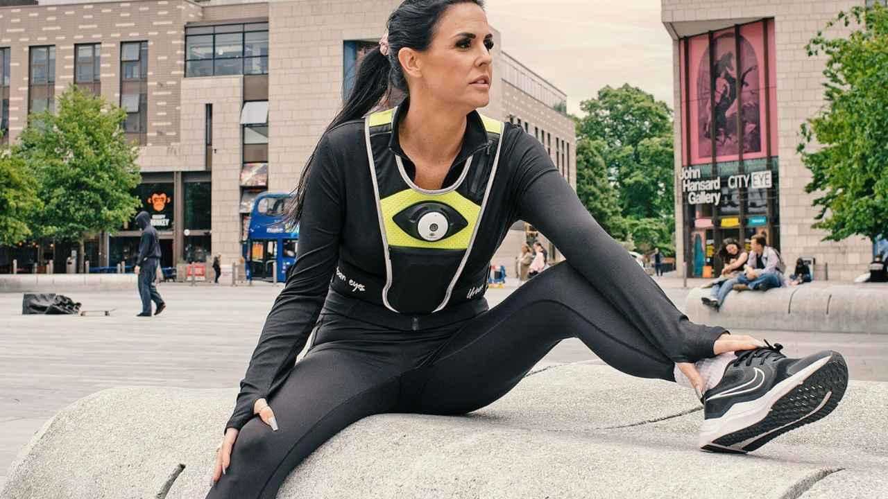 A woman wearing an Urban Eyes camera safety vest