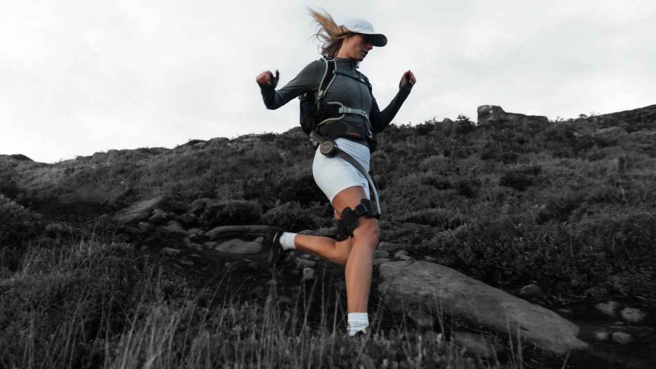 A woman hiking while wearing the Hypershell X Ultra exoskeleton 