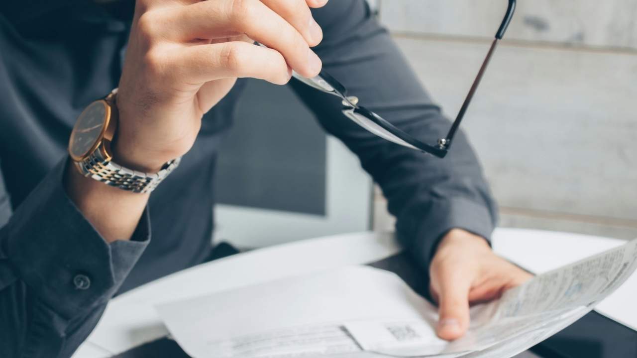 A man looking at public probate records at his desk 
