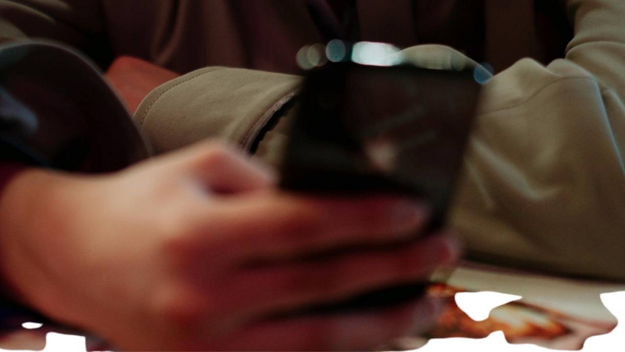 Illustration of a teen using apps on his cell phone 