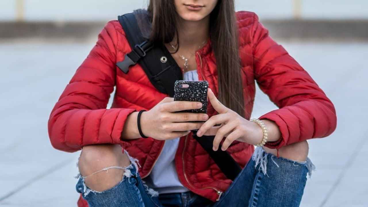 A teen using an AI chatbot on her phone 