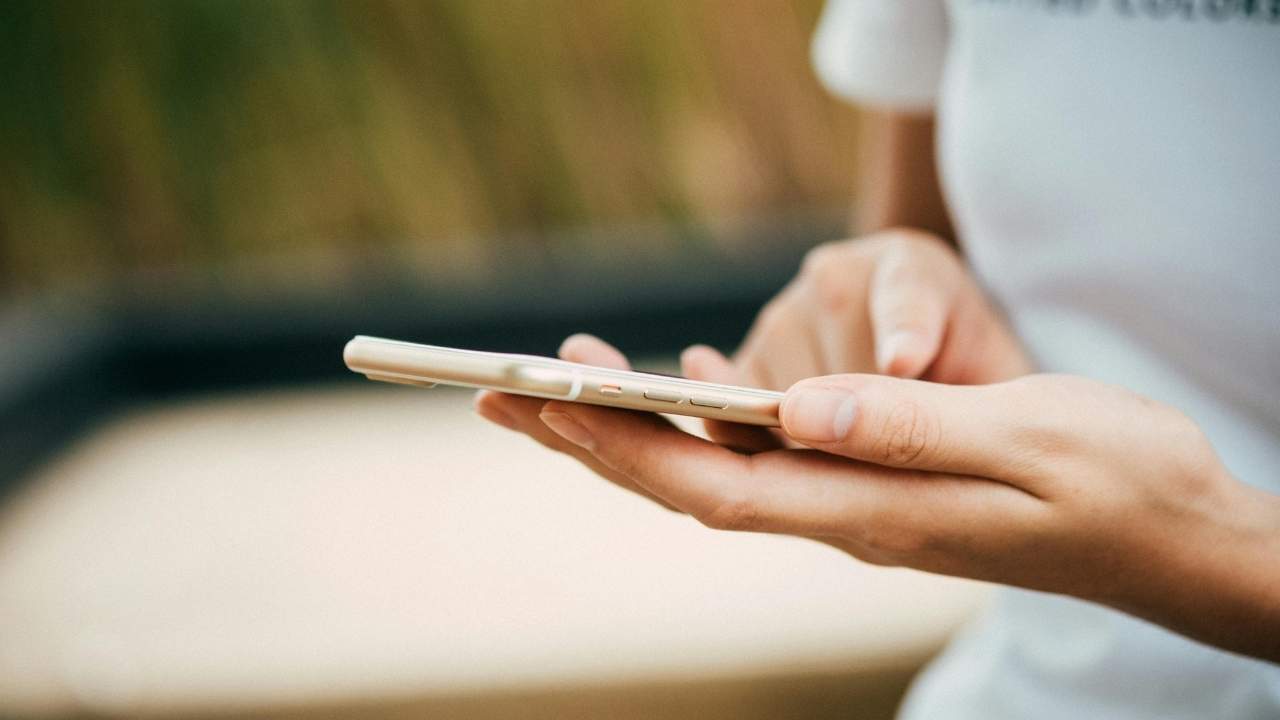 A woman changing the settings on her phone