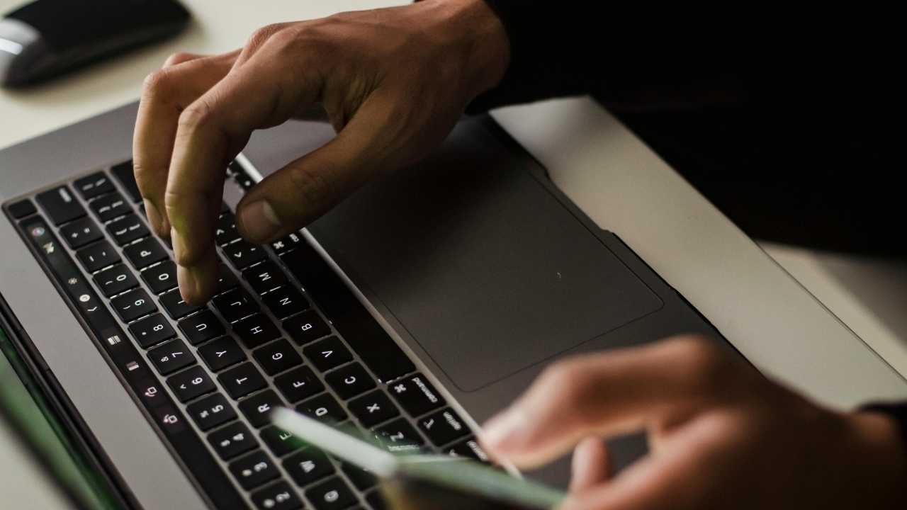 A man typing on his laptop