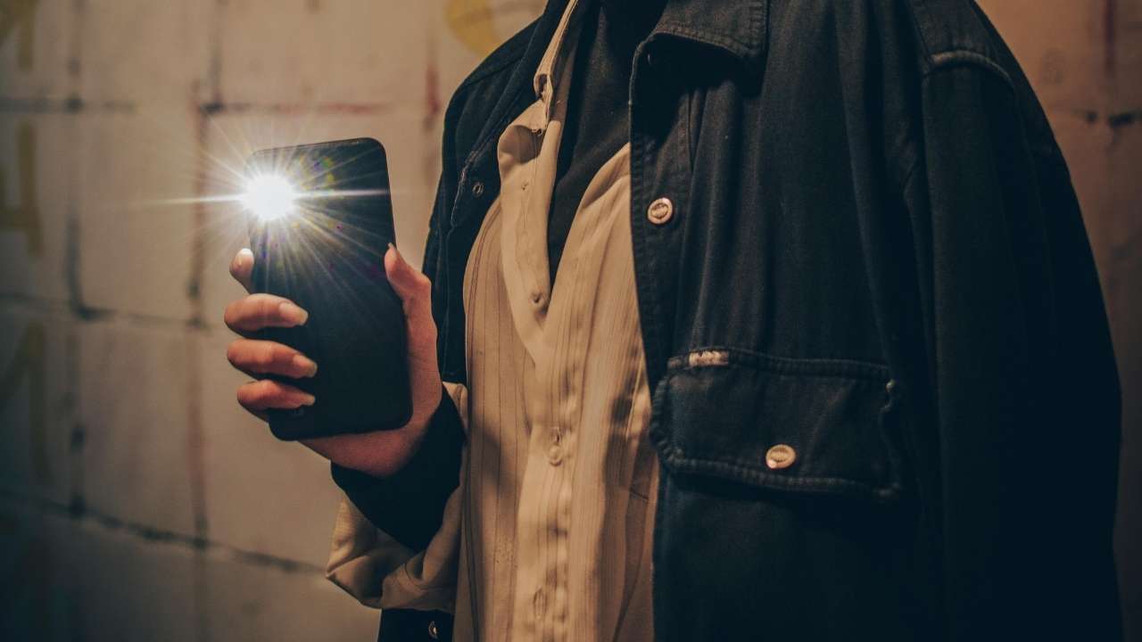 Image of a person using their phone's flashlight 