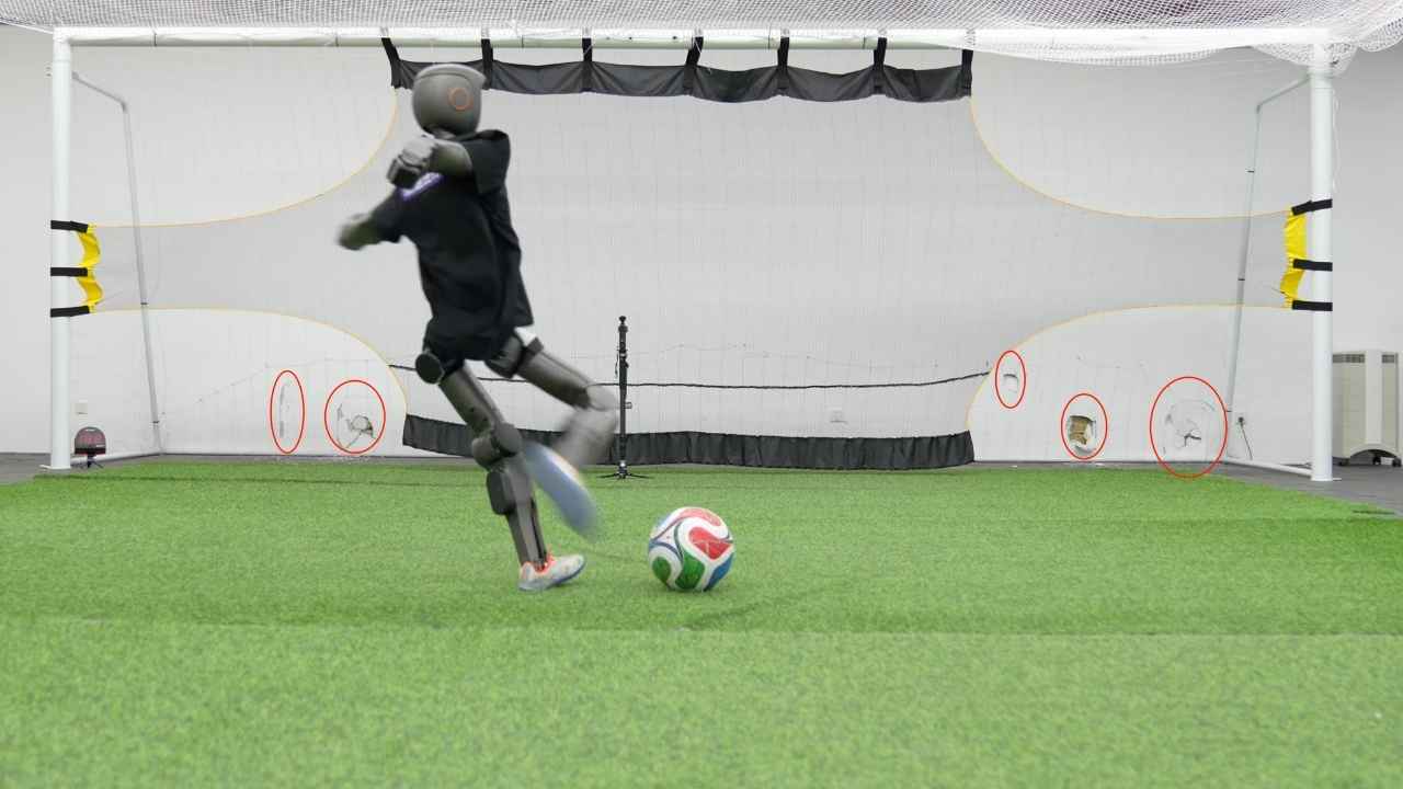 Booster Robotics’ T1 humanoid robot lines up a soccer kick inside the company’s lab, where its shots hit with enough force to dent the wall.