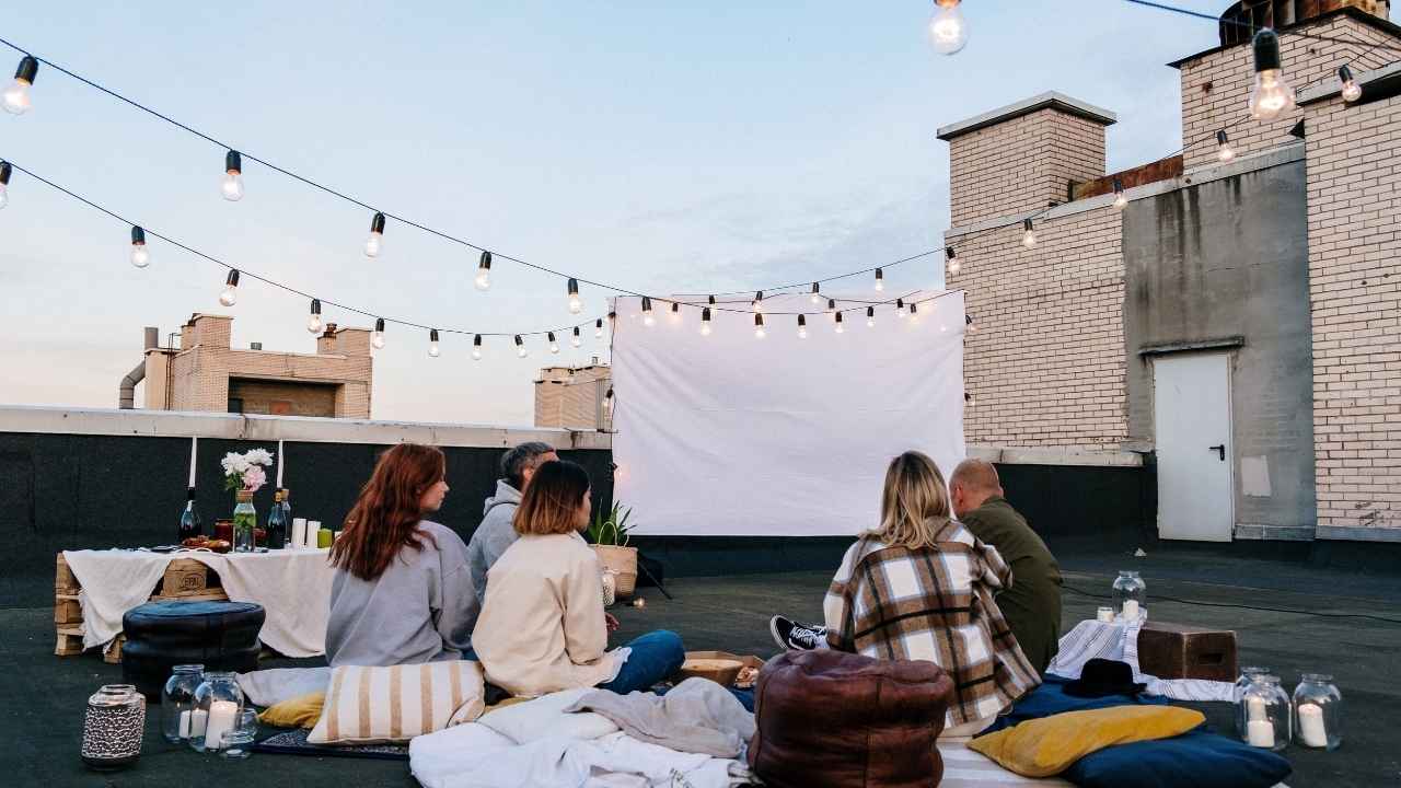 A projector setup gives your trip photos a big-screen feel for family gatherings, parties or summer nights outside.
